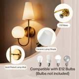 Gold double-headed wall sconce with ceramic shades, shown mounted on wall