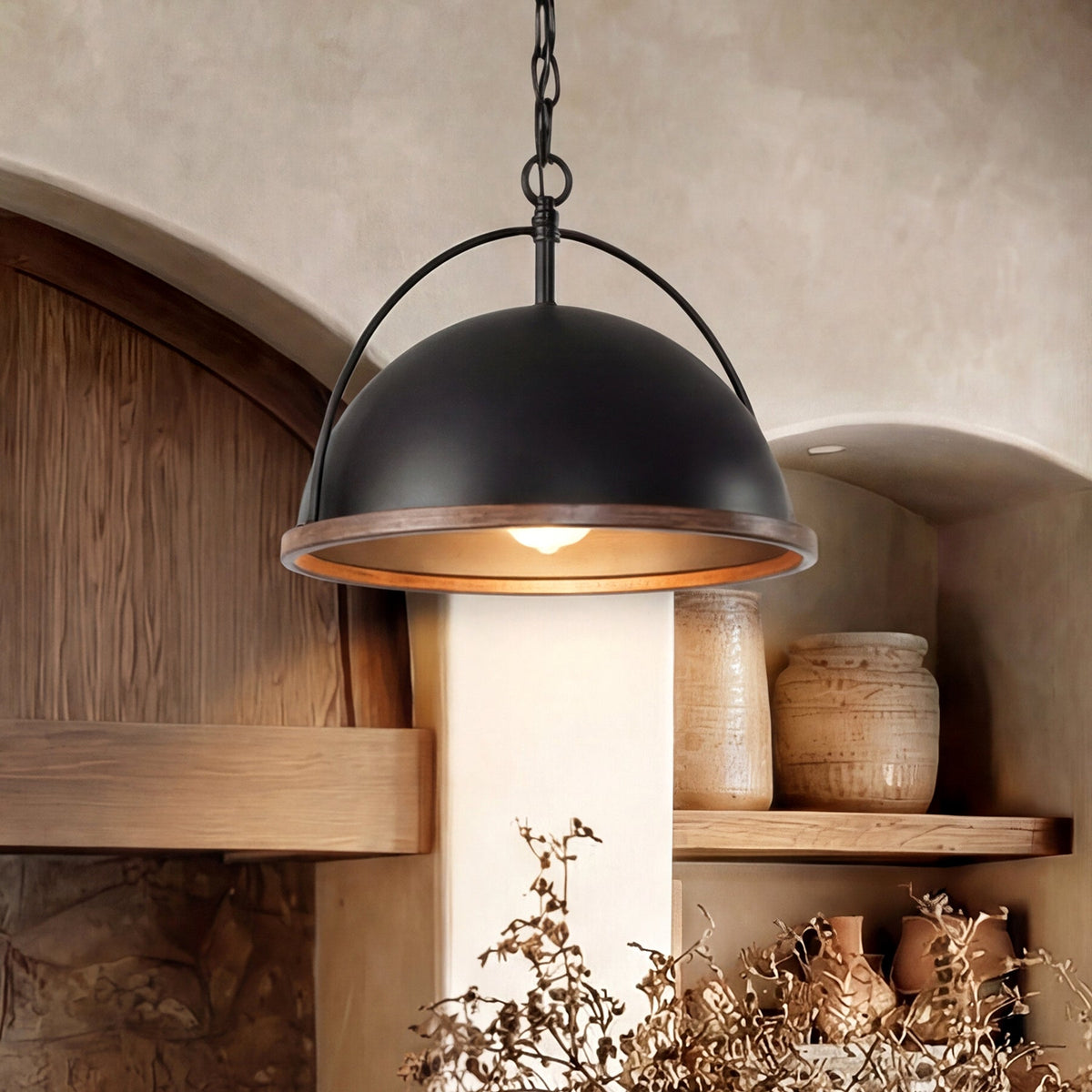 Black dome pendant light with wood trim hanging in a rustic kitchen setting