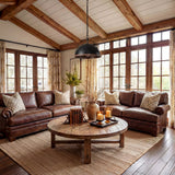 Black dome pendant light with wood grain trim and adjustable chain hanging in a rustic living room