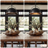 Black dome pendant light with wood trim, shown lit in a dining room