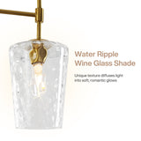 Brushed gold chandelier with water ripple glass shade, shown from side angle