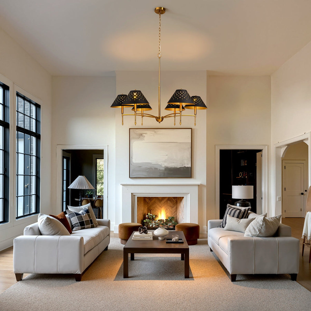 Farmhouse chandelier with matte black shades and gold frame hanging in a living room