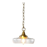 Gold pendant light with clear glass shade, hanging by adjustable chain and swivel joint