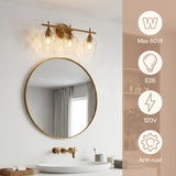 Brushed brass vanity light with three water ripple glass shades above a round mirror in a bathroom