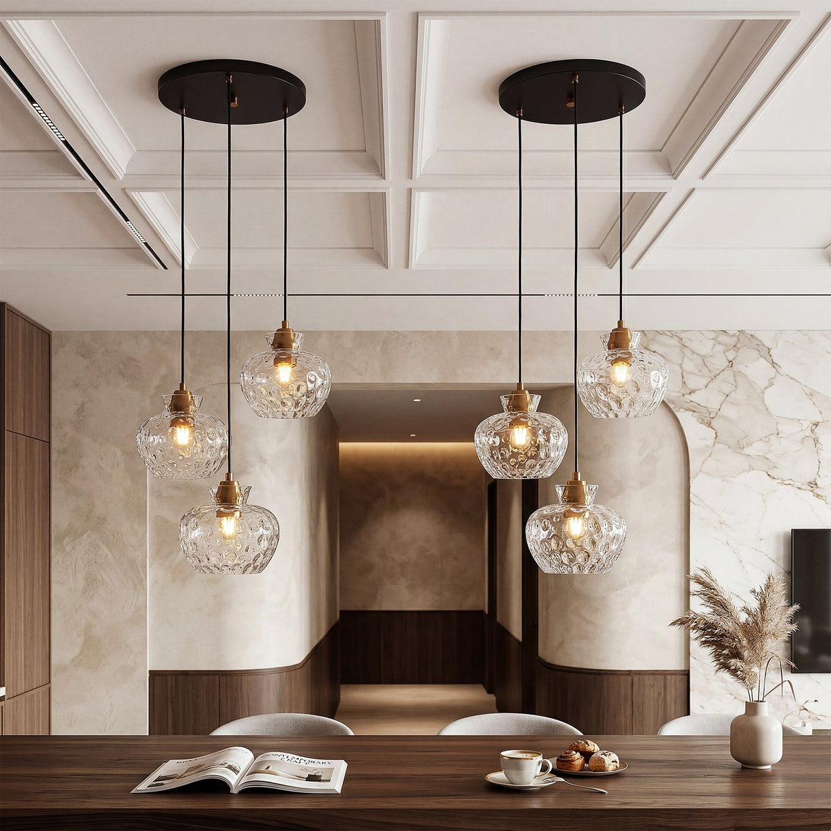 Black and gold three-light pendant with water ripple glass shades, shown from a low angle over a dining table