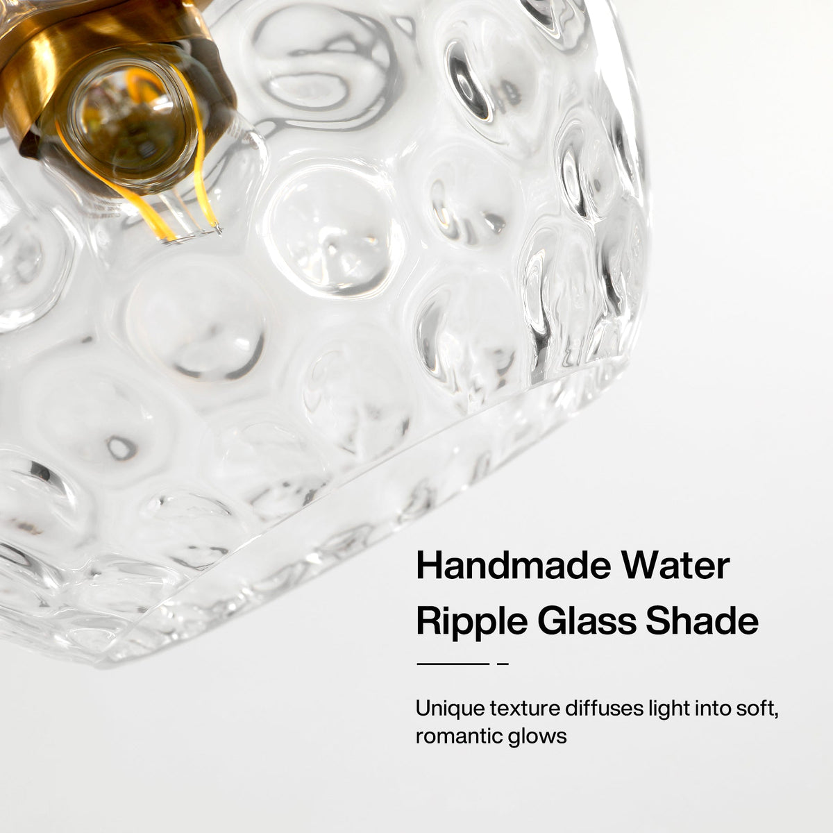 Close-up of a gold-finished light bulb inside a clear water ripple glass shade