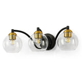 Black and brass three-light vanity light with clear globe shades, shown from front angle