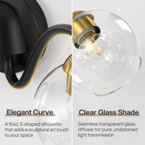Close-up of black and brass bathroom vanity light with clear glass shades