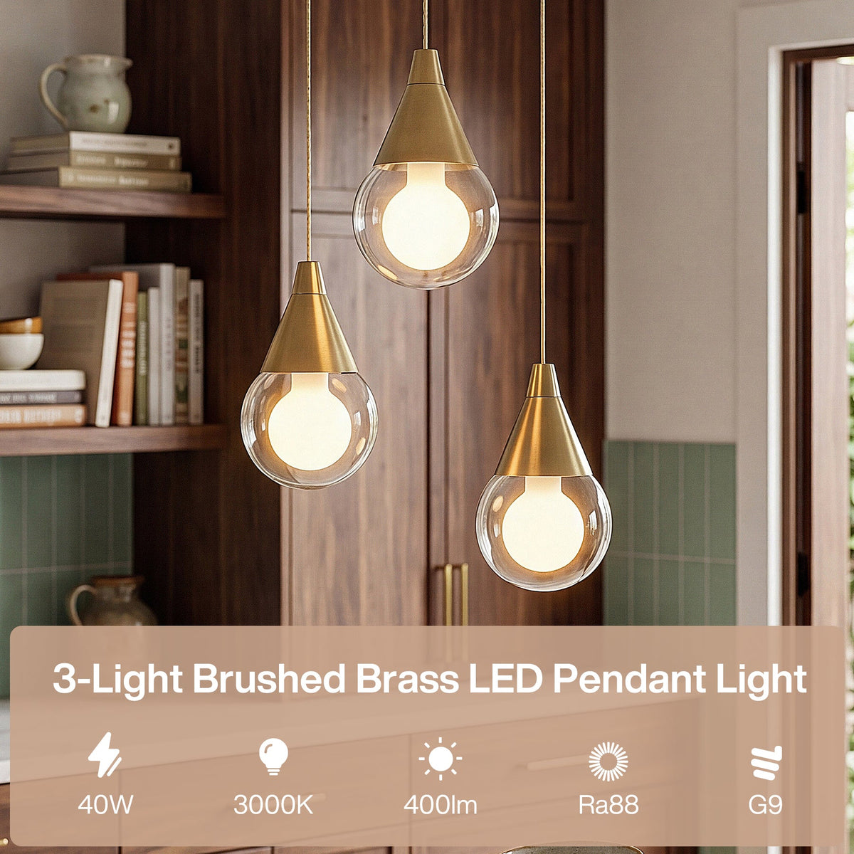 Three brushed brass pendant lights with glass globes hanging in a kitchen