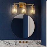 Brushed gold bathroom vanity light with three ribbed glass shades mounted above a round mirror