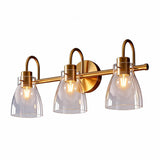 Three-light brushed brass vanity light with clear glass shades, shown from front angle