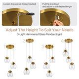 Adjustable brushed brass pendant light with three hammered glass shades, shown at four height settings