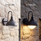 Black outdoor wall lantern with frosted glass shade, shown off and on against stone wall