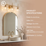 Brushed brass bathroom vanity light with three clear globe shades mounted above a mirror