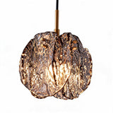 Black and gold pendant light with smoky glass shade, shown from front angle