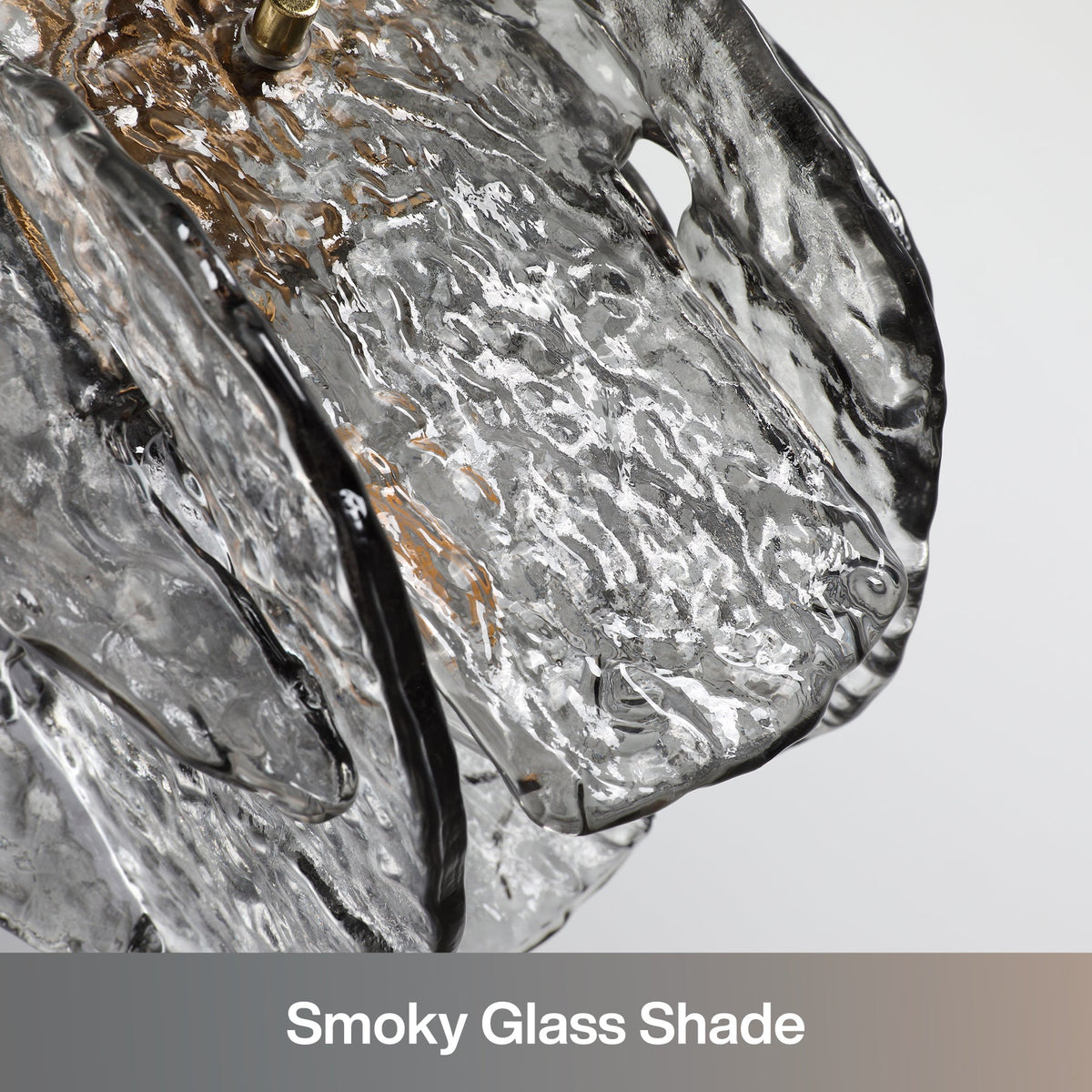 Close-up of smoky glass shade with black and gold accents on pendant light