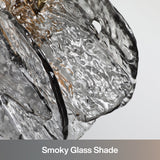 Close-up of smoky glass shade with black and gold accents on pendant light