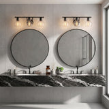 Matte black bathroom vanity light with three clear glass shades, shown above round mirrors in a modern bathroom