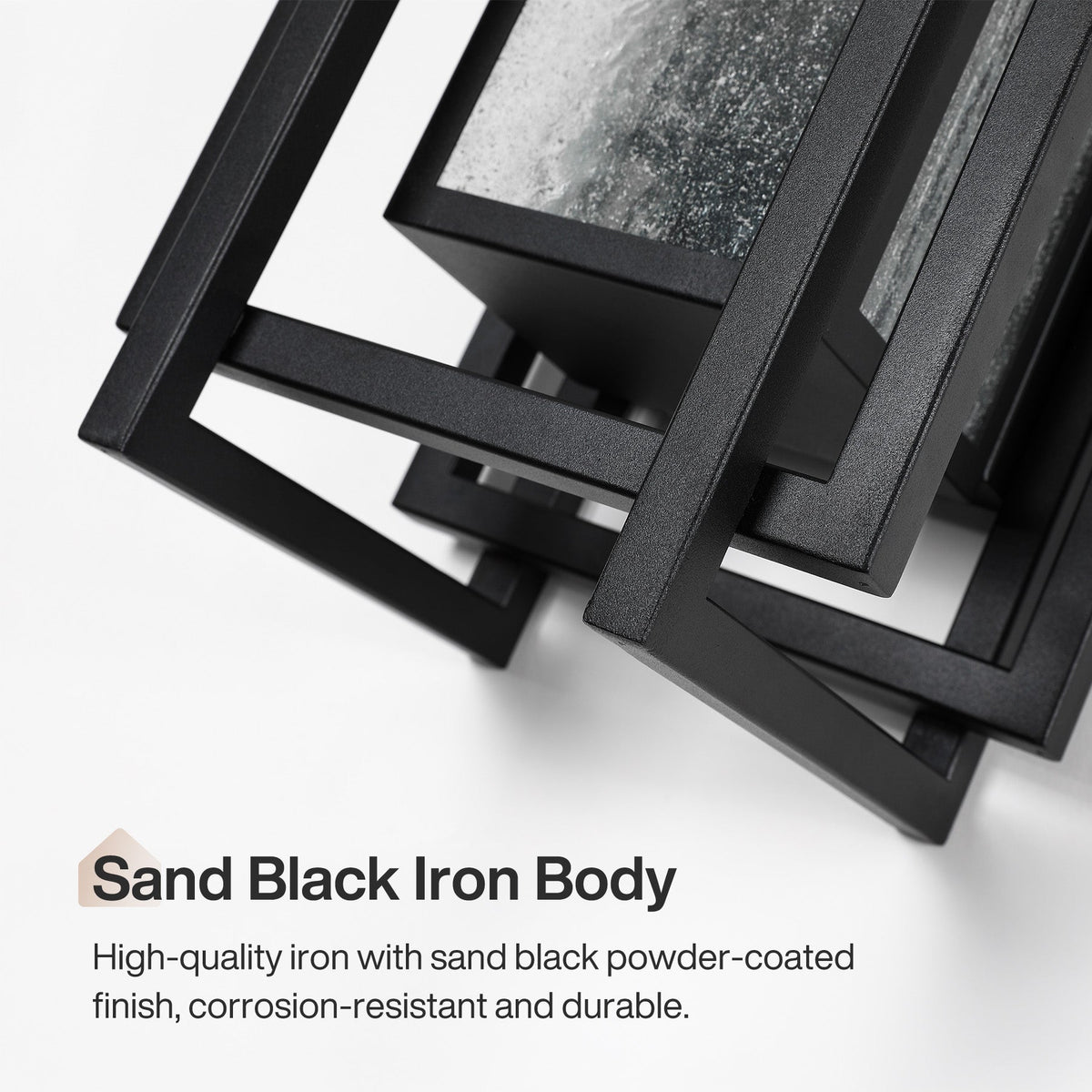 Black outdoor wall sconce with seeded glass, angled view showing sand black iron body