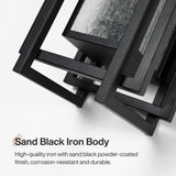 Black outdoor wall sconce with seeded glass, angled view showing sand black iron body