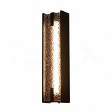 Tall black outdoor wall sconce with water ripple acrylic panel, lit from within