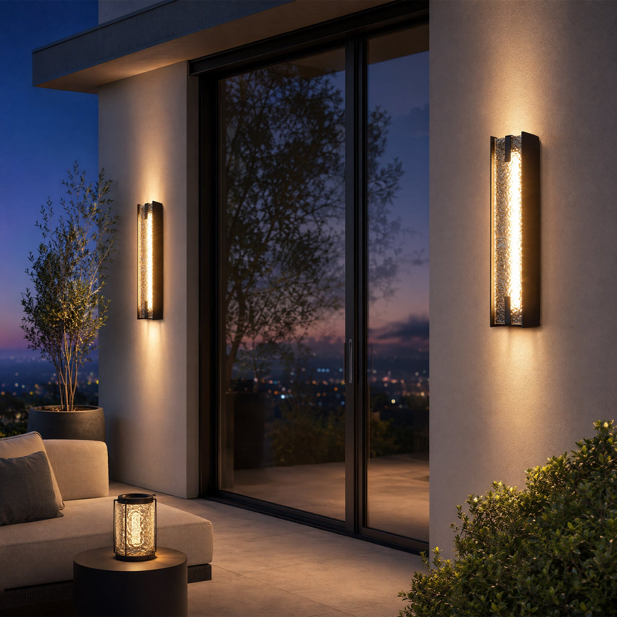 Black LED outdoor wall sconce with water ripple acrylic, shown mounted on wall beside glass door at dusk