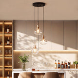 Black and gold three-light pendant with water ripple glass, hanging over a bar counter