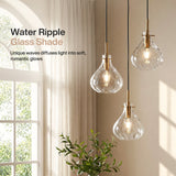 Three black and gold pendant lights with water ripple glass shades hanging in a room near a window