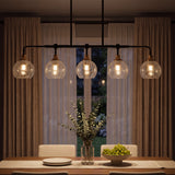 Five-light black and gold chandelier with crackle glass shades over a dining table