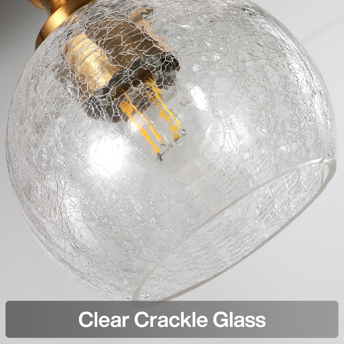 Close-up of clear crackle glass shade with gold fixture and LED bulb