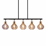 Five-light linear chandelier with ripple glass shades, black metal frame, and gold accents, viewed from front