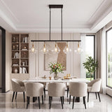 Five-light linear chandelier with ripple glass shades, black frame, and gold accents hanging over a dining table