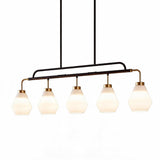 Five-light kitchen island pendant with frosted white glass shades, black and brass frame, shown from front