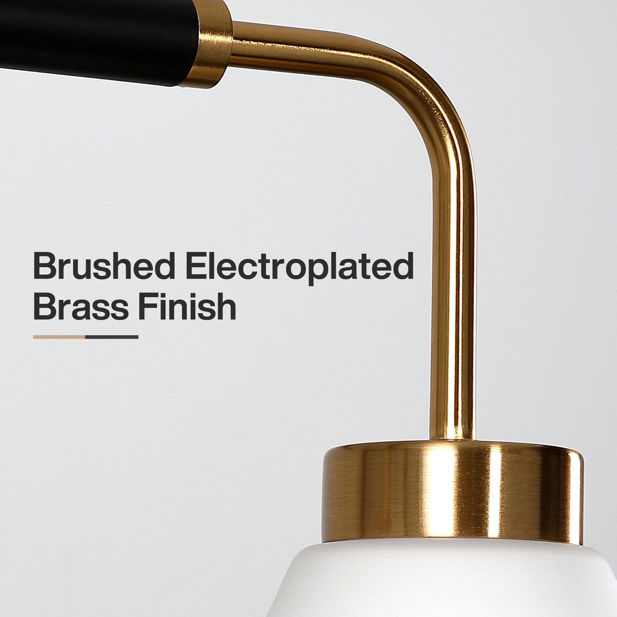 Close-up of a five-light kitchen island light with frosted white glass, black and brushed electroplated brass finish