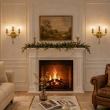 Three-light gold wall sconce with brass finish, mounted on wall above fireplace in living room