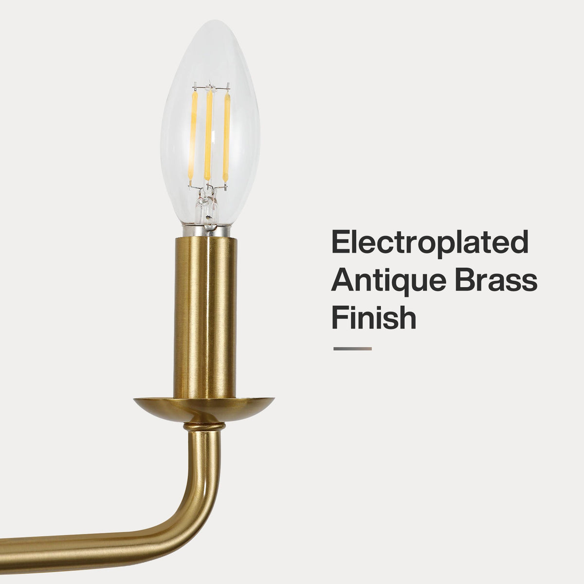 Close-up of a gold electroplated brass candle-style wall light with a visible LED bulb
