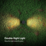 Two warm white LED lights embedded in grass, showing illuminated circular patterns