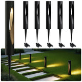 Six black waterproof LED path lights with warm white glow, shown installed in grass near stone walkway