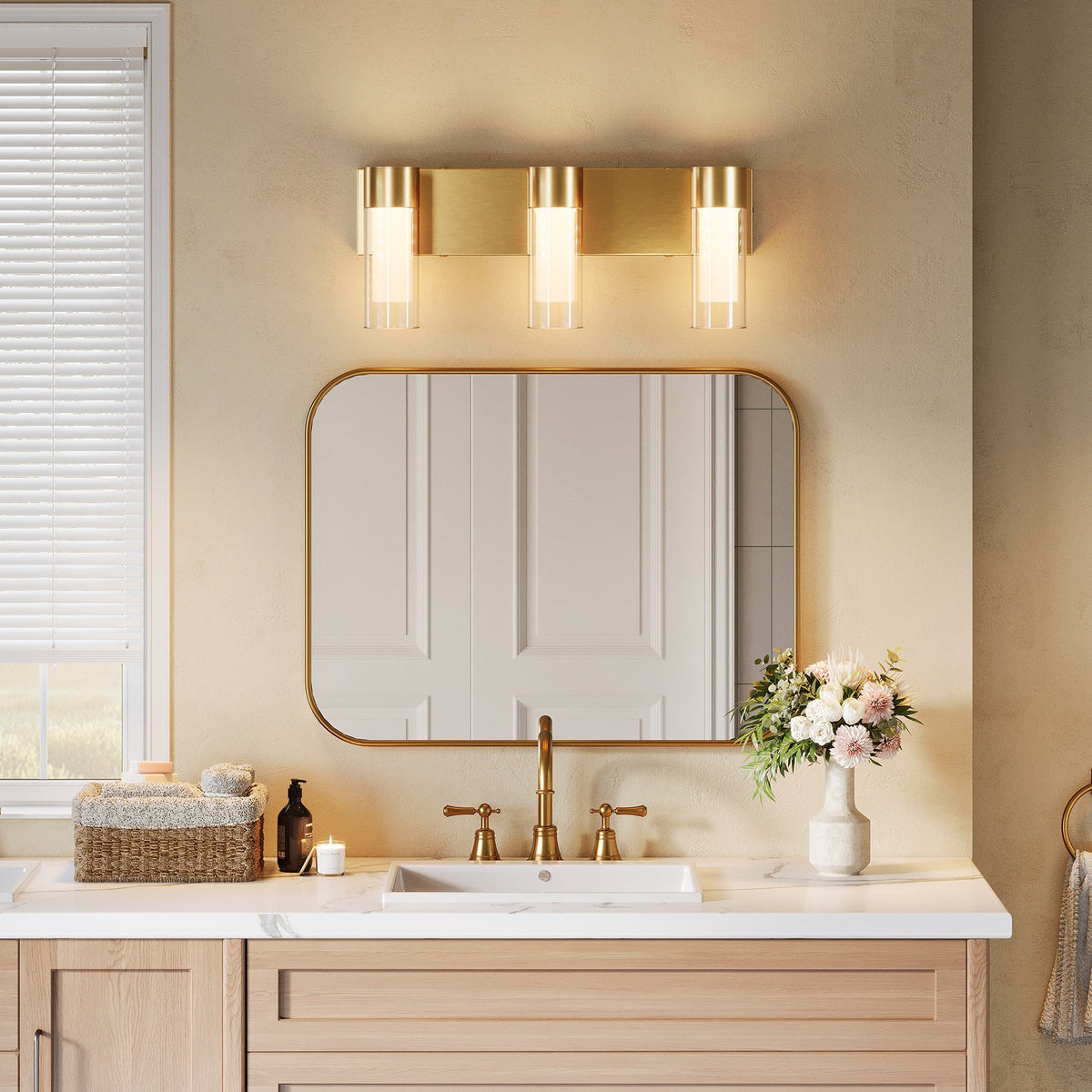 Gold LED bathroom vanity light with three cylindrical bulbs mounted above a mirror
