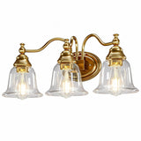 Gold bathroom vanity light with three clear glass bell shades, shown from front angle