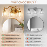Gold bathroom vanity light with three clear glass bell shades, shown mounted above a round mirror in a bedroom