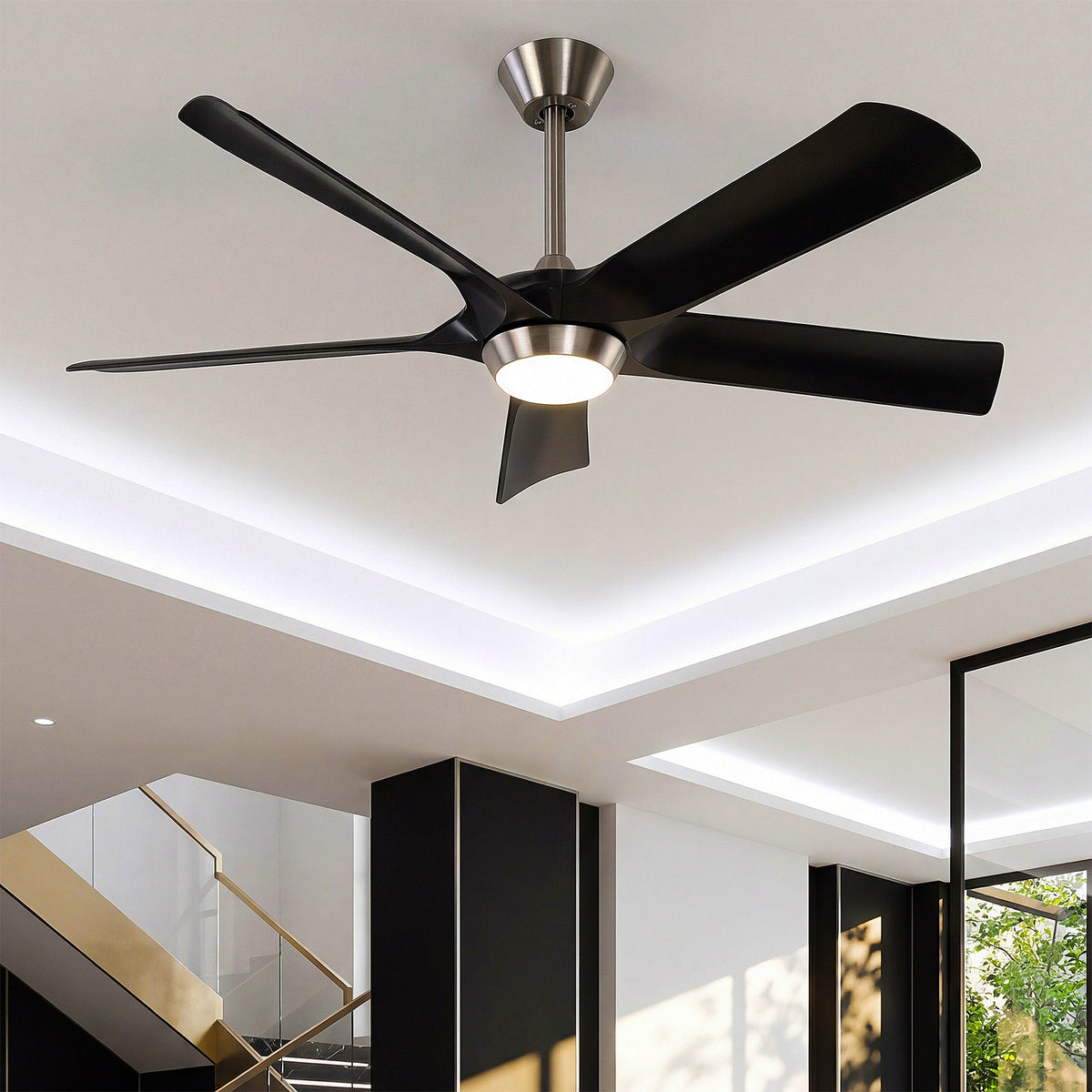 Black ceiling fan with five blades and integrated light, viewed from below in a modern room
