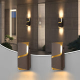 Two brown LED outdoor wall lights with gold trim mounted on a tiled wall, emitting warm light