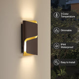 Brown and gold LED outdoor wall light mounted on a wall, emitting warm light