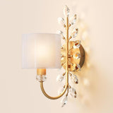 Gold crystal leaf wall sconce with fabric shade, shown at an angle