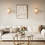 Gold crystal leaf wall sconce with fabric shade, shown in a living room setting