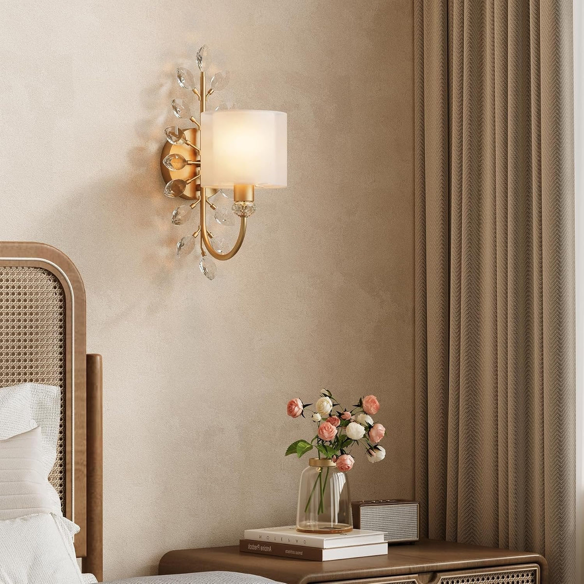 Gold crystal leaf wall sconce with fabric shade mounted on beige wall beside bed
