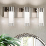 Three-light brushed nickel LED vanity light with frosted glass shades mounted above a mirror