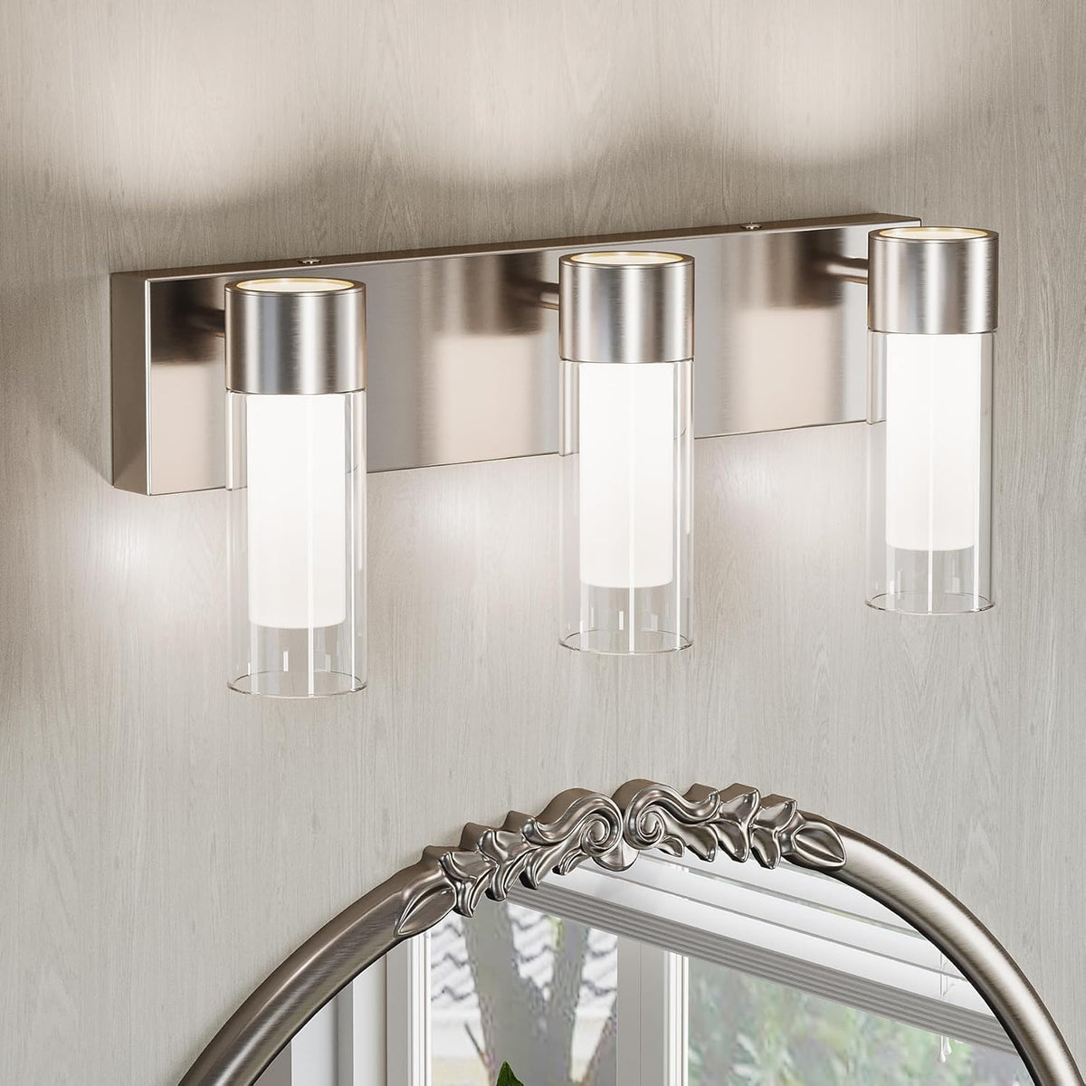 Three-light brushed nickel LED vanity light above a mirror in a bathroom