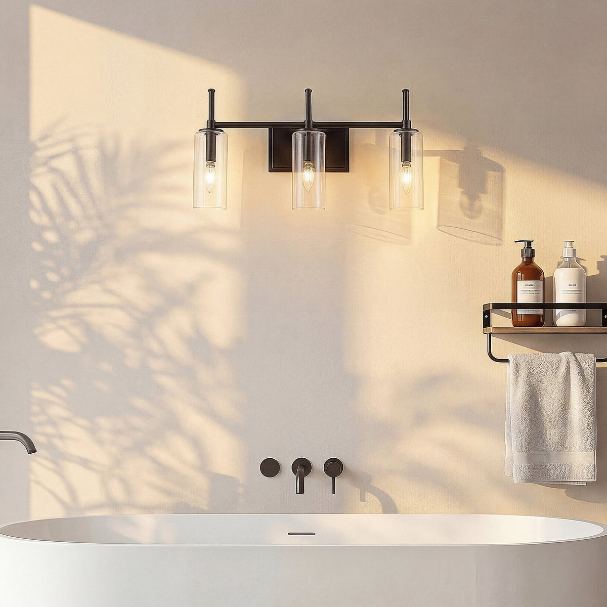 Black three-light vanity fixture with clear cylinder glass shades over a white bathtub